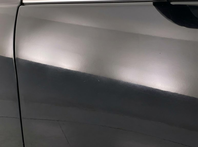 Close-up of glossy but slightly faded black car paint